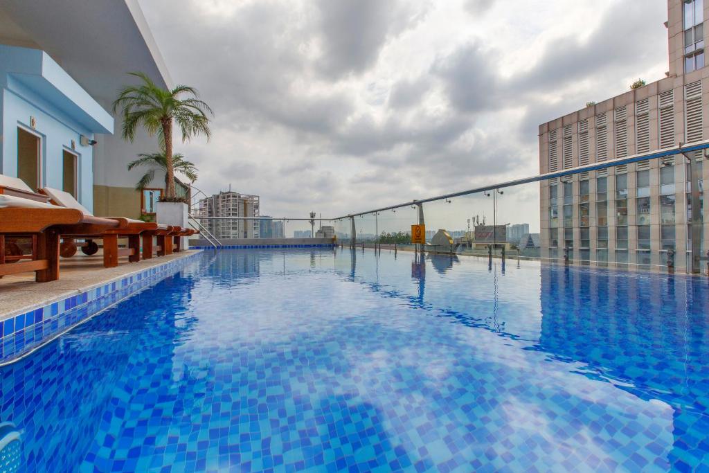 a large blue swimming pool in a building at Huong Sen Annex Hotel in Ho Chi Minh City