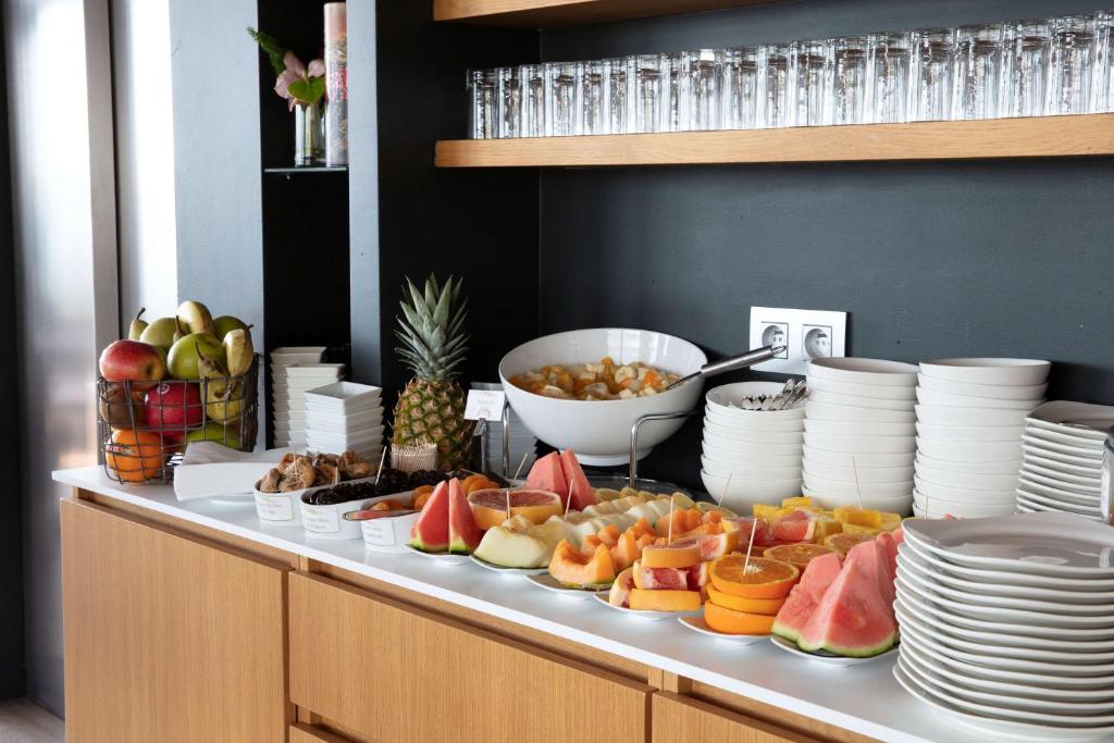 a buffet with a variety of fruit on a table at Best Western Hôtel Alcyon in Porto-Vecchio