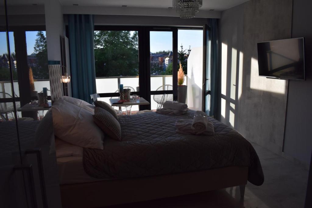 Televízia a/alebo spoločenská miestnosť v ubytovaní Apartament Silence Triventi Cristal