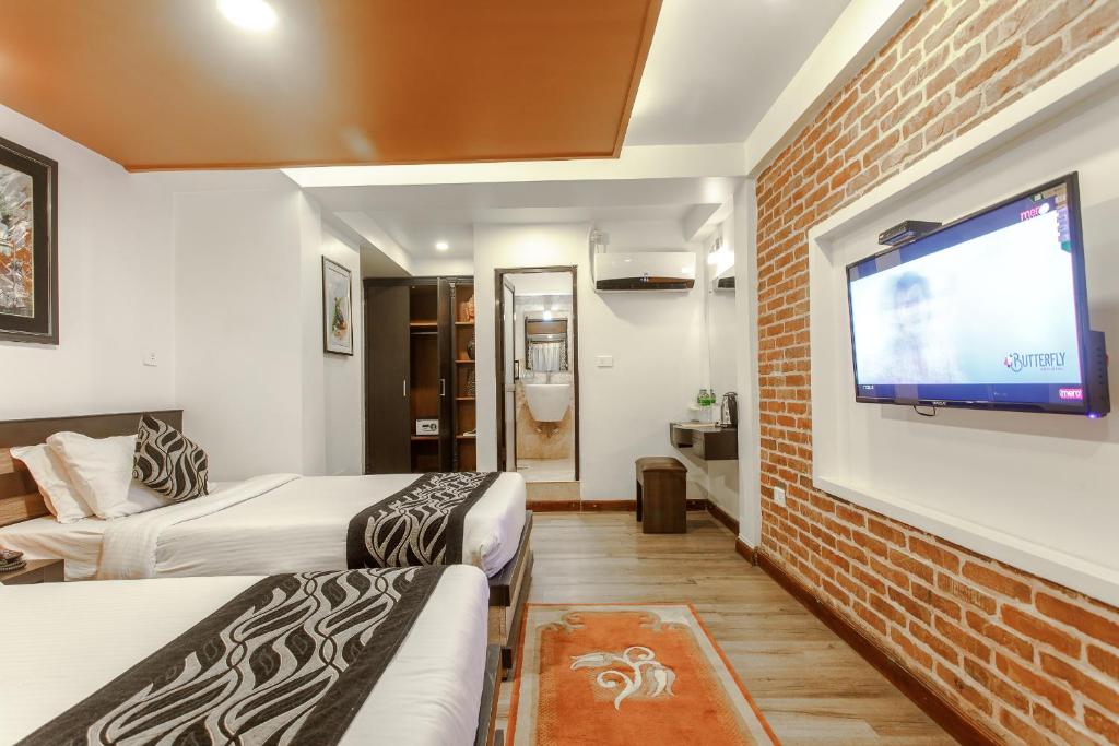 Postel nebo postele na pokoji v ubytování Hotel Shreesu