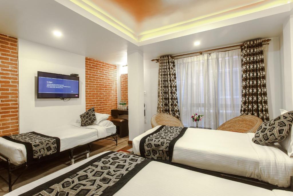 Postel nebo postele na pokoji v ubytování Hotel Shreesu