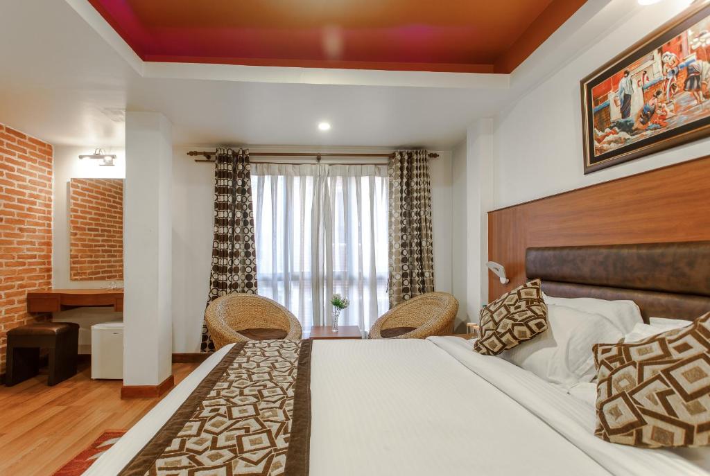 Postel nebo postele na pokoji v ubytování Hotel Shreesu
