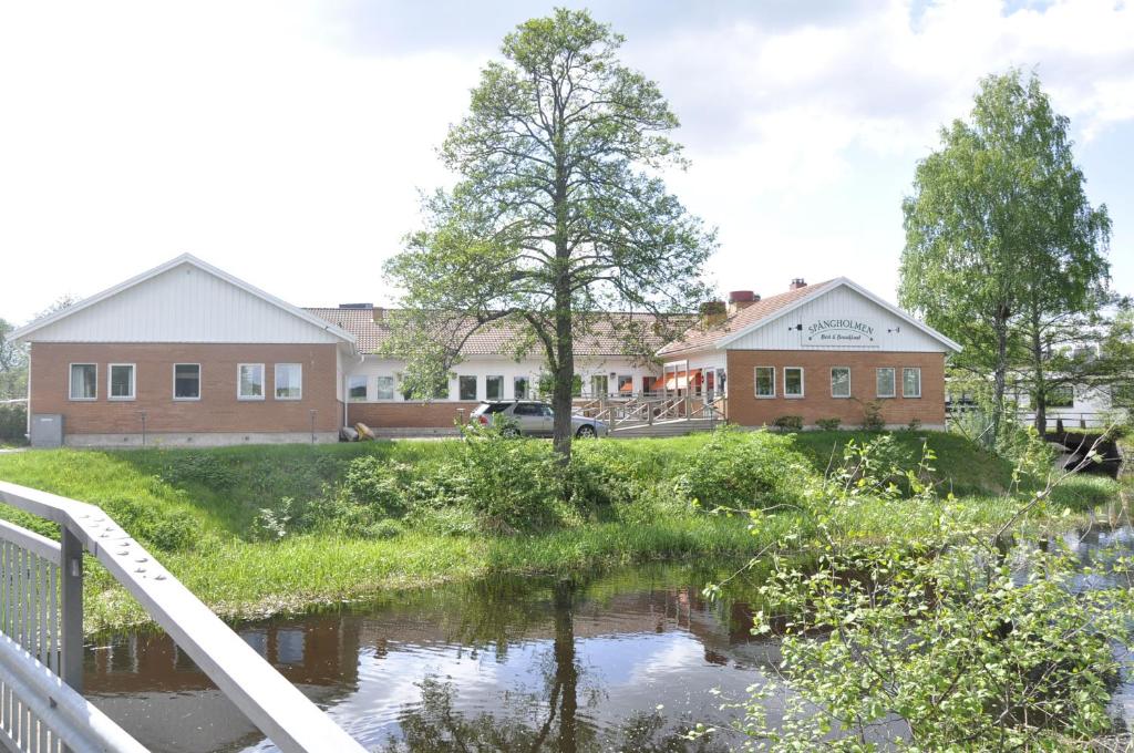 un ponte su un fiume di fronte a una casa di Spångholmen B & B a Mjölby