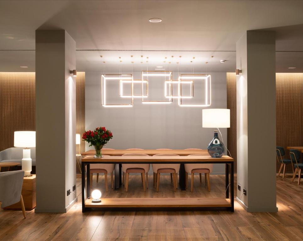 a dining room with a table with chairs and lights at Hotel Ciudad de Logroño in Logroño