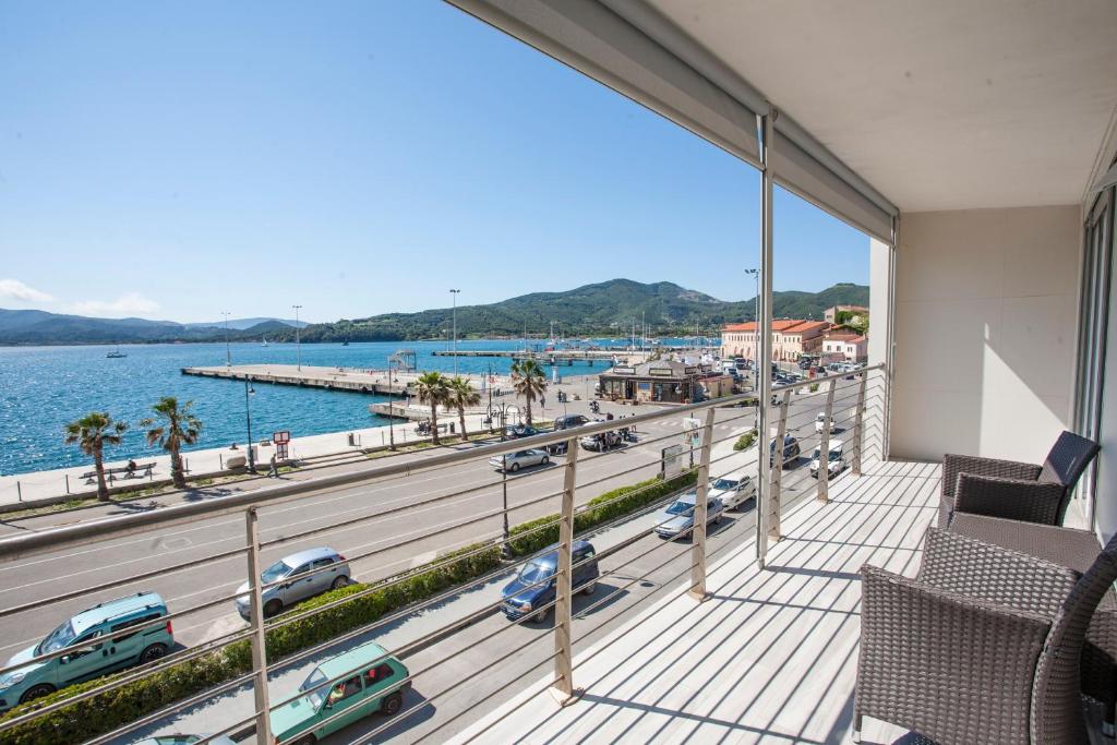 a balcony with a view of a road and cars at Appartamenti Lungomare Portoferraio - Goelba in Portoferraio