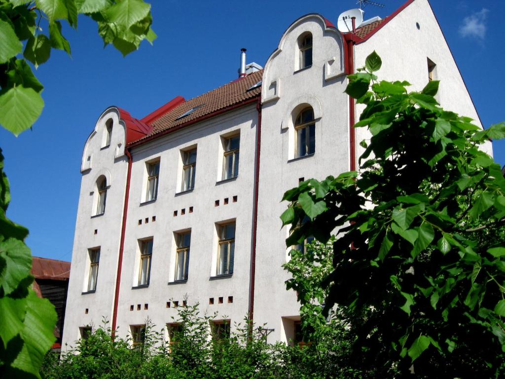 a large white building with a red roof at Hotel Katrina in Cēsis