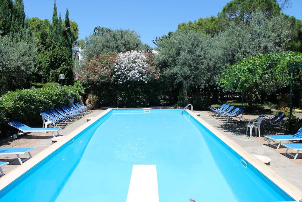 a swimming pool with lounge chairs and trees at Casa Lucky - Anacapri in Anacapri