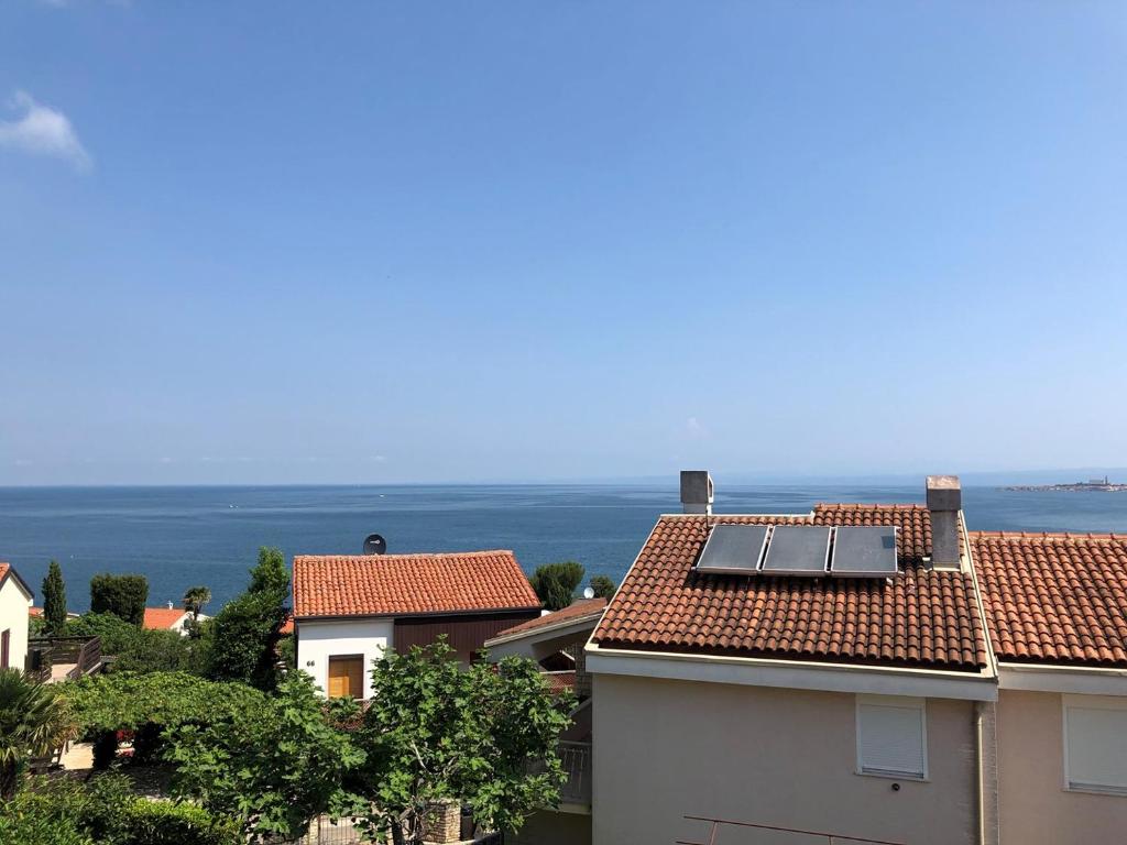 a view of roofs with a view of the ocean at Apartment Gioia in Savudrija