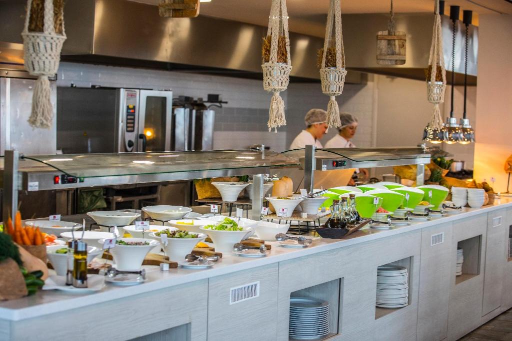 a buffet line in a restaurant with people preparing food at Leonardo Cypria Bay in Paphos