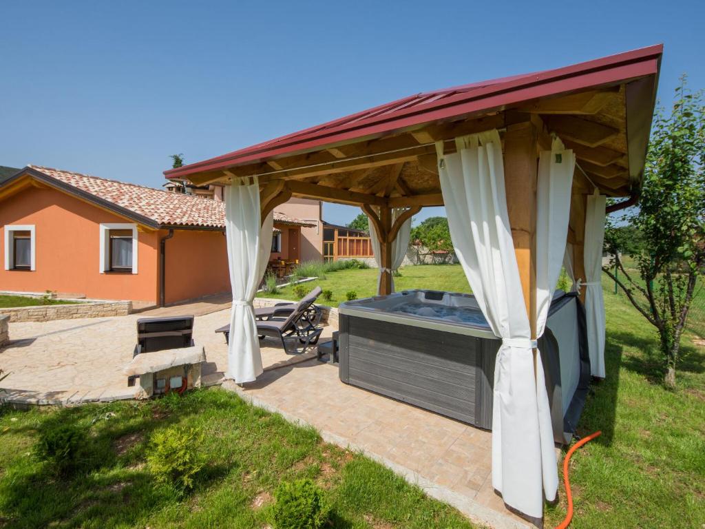 a gazebo with a hot tub in a yard at Attractive Holiday Home with Pool bubble bath Patio Courtyard in Barbariga