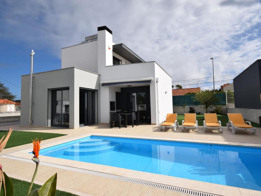 a villa with a swimming pool in front of a house at Lavish Villa in Foz do Arelho with Private Pool in Foz do Arelho