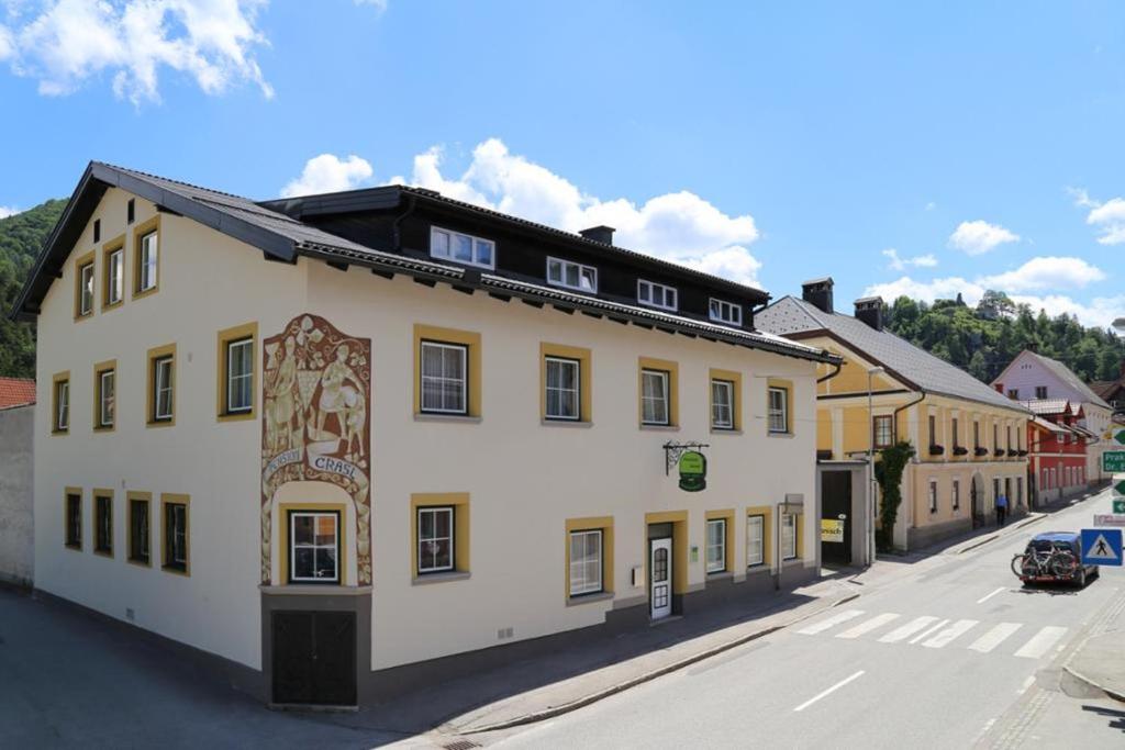 a large white building on the side of a street at Pension Grasl in Hohenberg