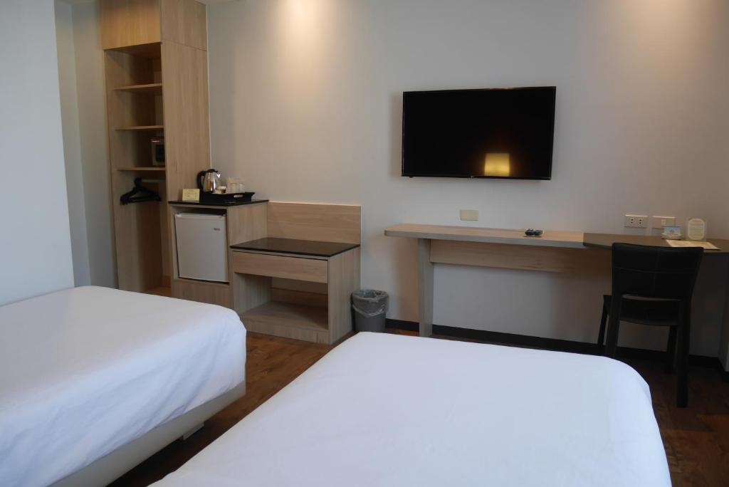 Postel nebo postele na pokoji v ubytování Circle Inn Hotel and Suites Bacolod