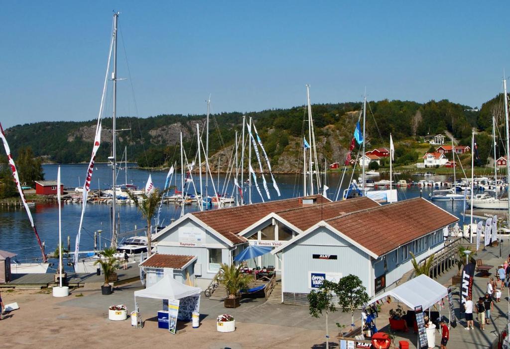 a marina with many boats in the water and people at Apartments in Henån in Henån