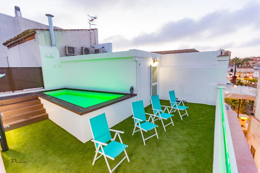 a backyard with a trampoline and chairs and a pool at Fumiko in Sanlúcar de Barrameda