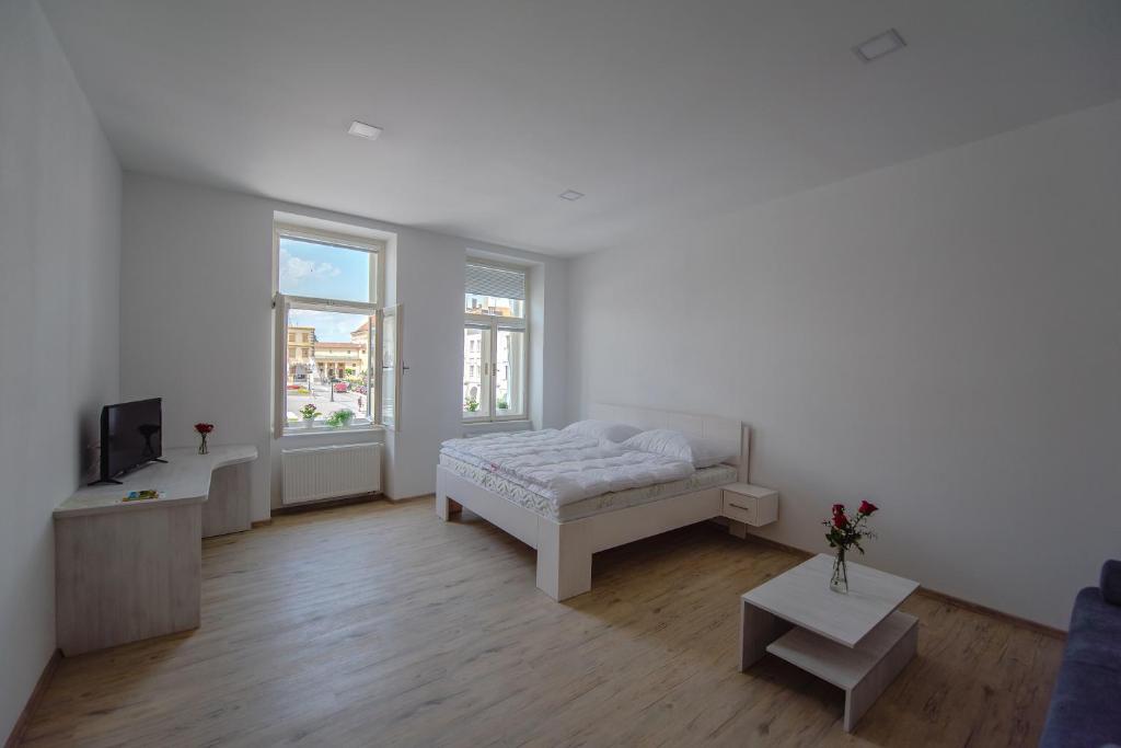 Postel nebo postele na pokoji v ubytování Apartmány Velké náměstí