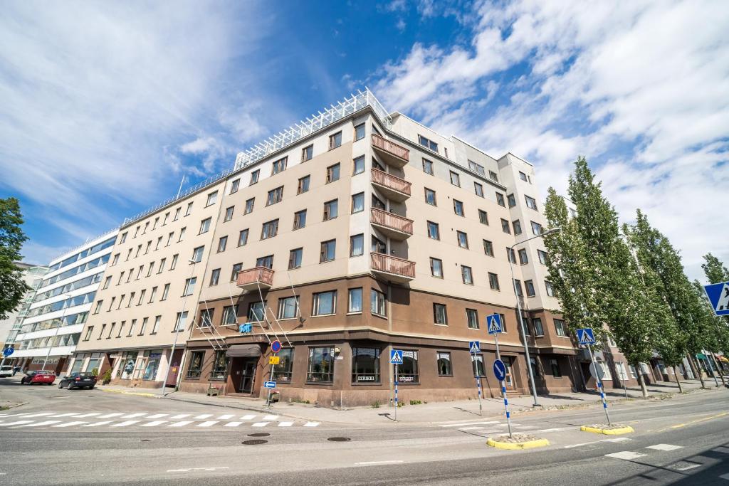 a large building on the corner of a street at Summer Hotel Tott in Savonlinna