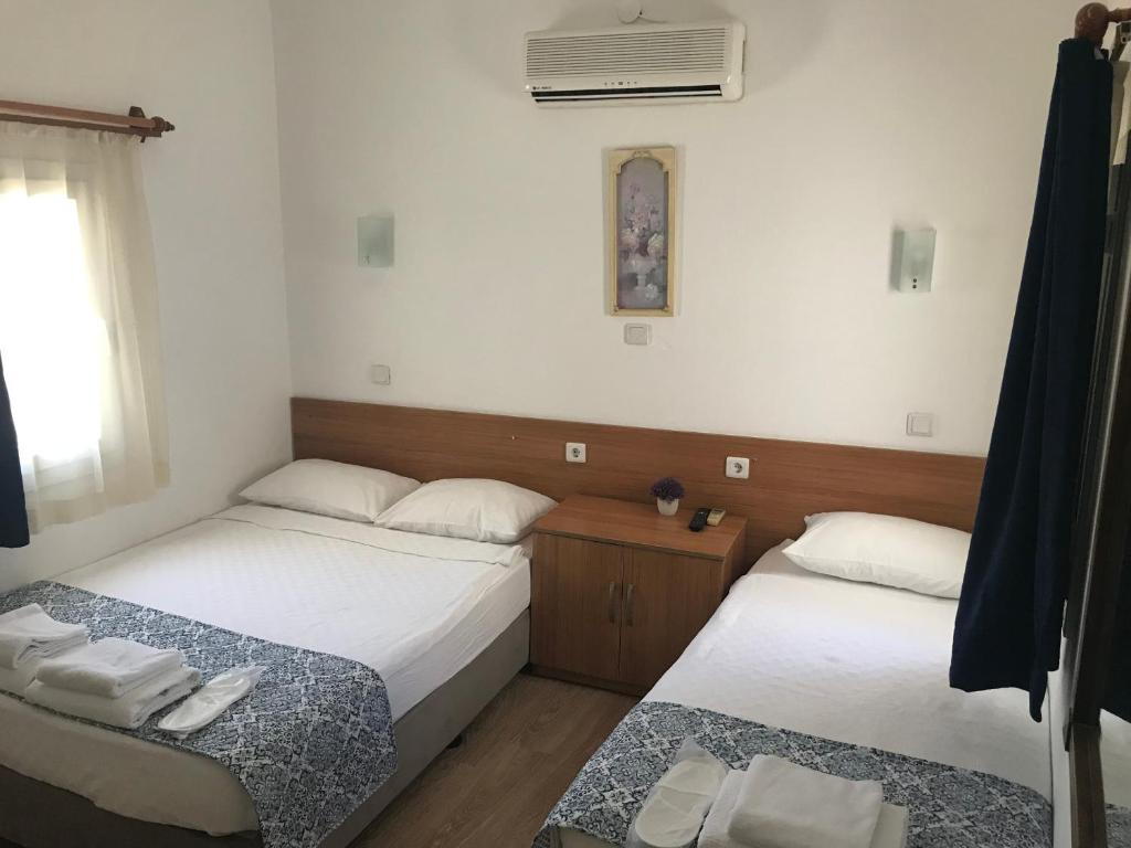 Postel nebo postele na pokoji v ubytování Tay Pansiyon