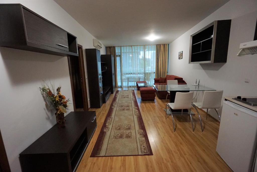 a living room with a kitchen and a dining room at Apartments in hotel Primorsko Del Sol in Primorsko