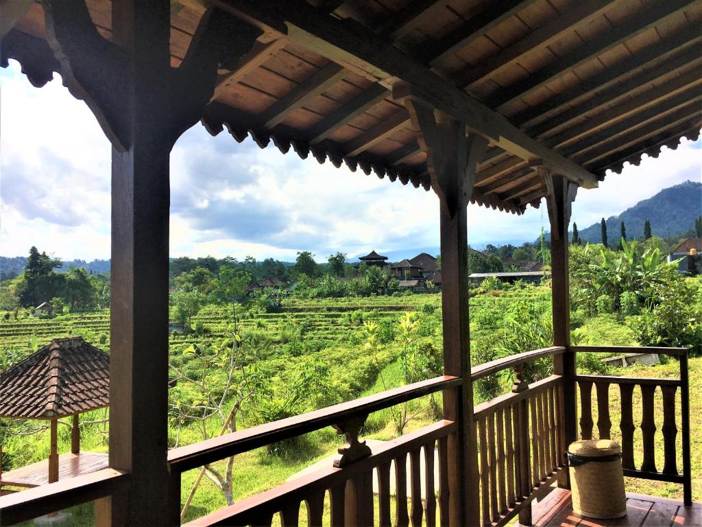 a view from a porch with a view of a field at Kubu Taru in Sidemen