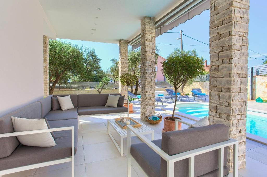 a living room with a couch and a table at Villa Vale in Kornić