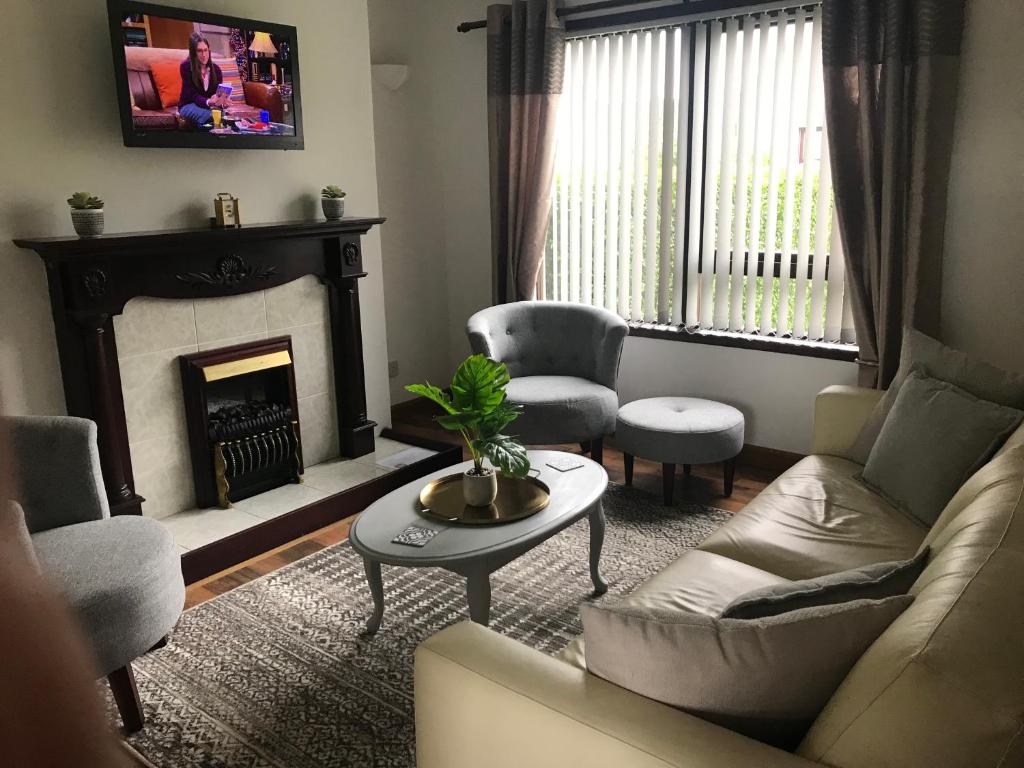 a living room with a couch and a fireplace at Hebridean Holiday House in Stornoway