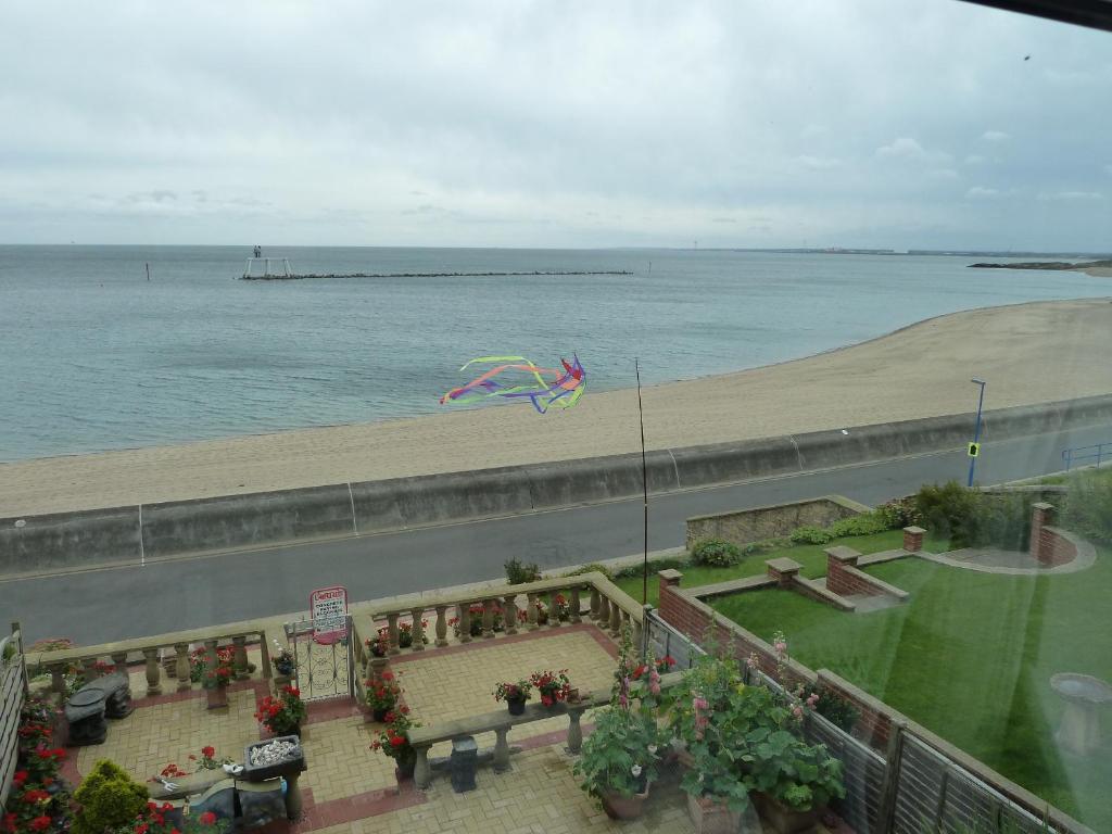 a kite flying in the air over the water at Captains Lodge in Newbiggin-by-the-Sea