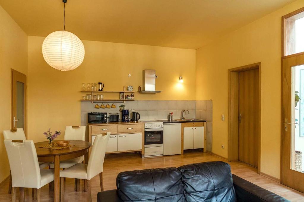 a kitchen and dining room with a table and a couch at Wohnen im Zentrum in Potsdam