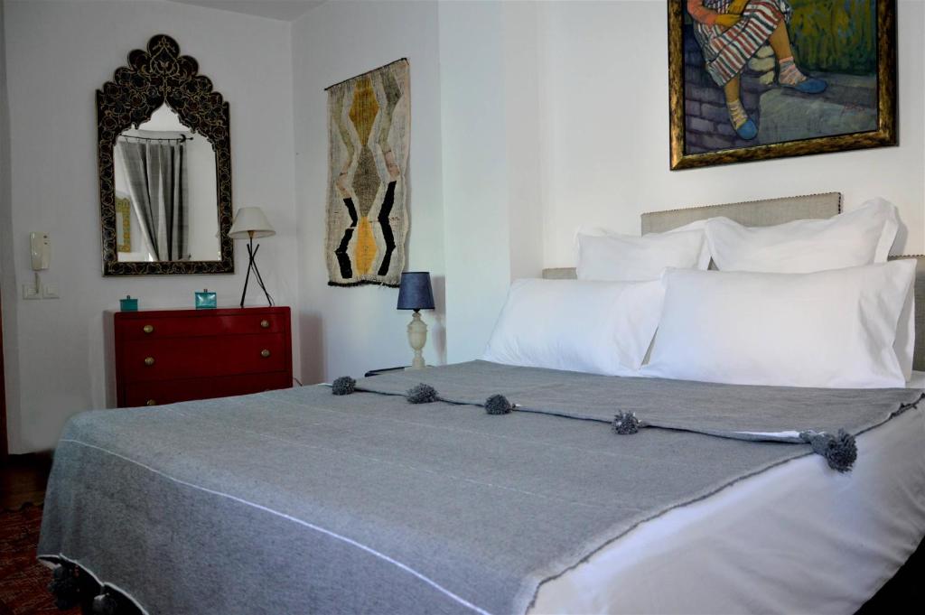 a bedroom with a bed and a mirror at RIAD OASIS D'ASILAH in Asilah