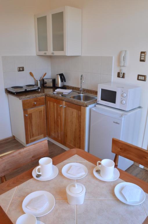 Kuchyň nebo kuchyňský kout v ubytování Apart Hotel Quillango