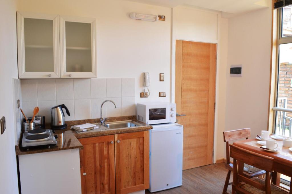 Kuchyň nebo kuchyňský kout v ubytování Apart Hotel Quillango