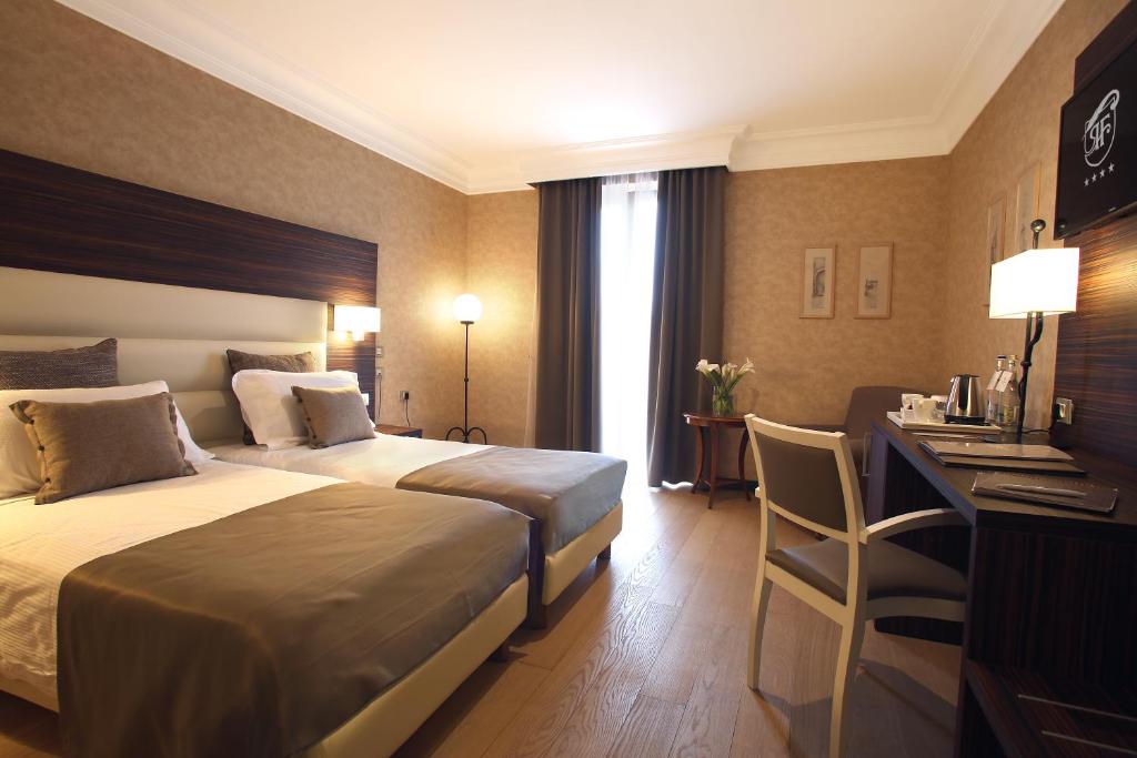 Postel nebo postele na pokoji v ubytování Relais La Fattoria