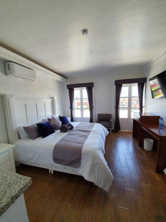 Postel nebo postele na pokoji v ubytování Hotel Estancia Real