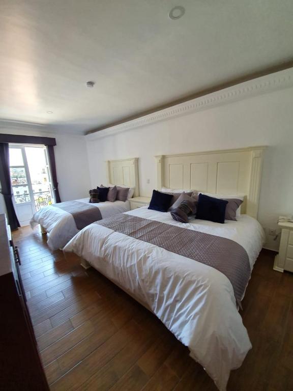 Postel nebo postele na pokoji v ubytování Hotel Estancia Real