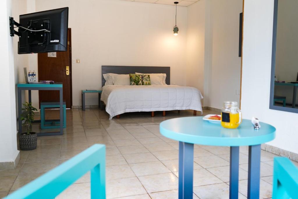 Postel nebo postele na pokoji v ubytování Hotel & Suites Arges - Centro Chetumal