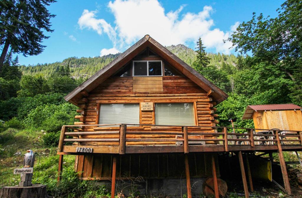 a cabin in the woods with a wrap around deck at Sweet Retreat Cabin in Leavenworth