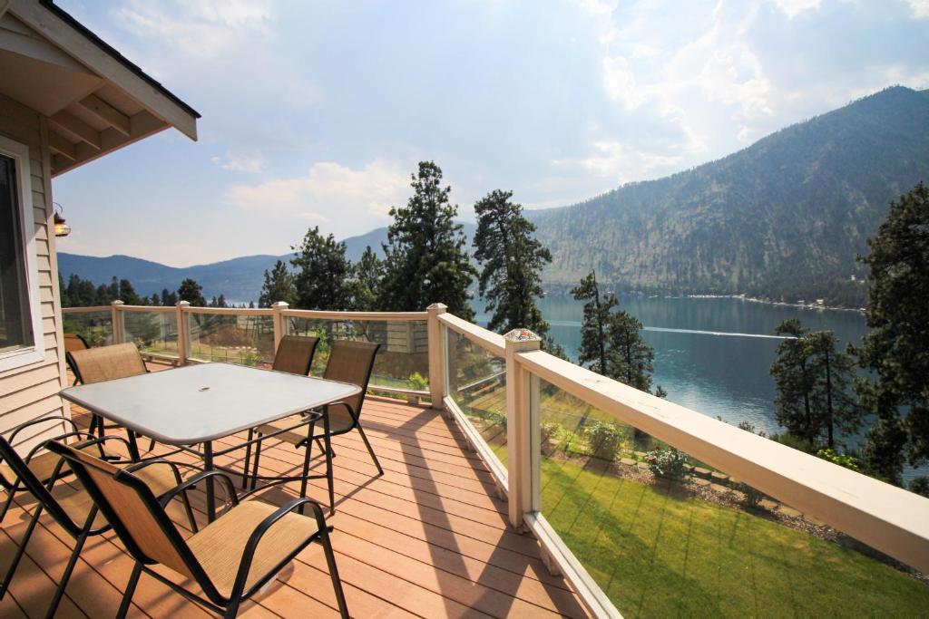 a balcony with a table and chairs and a view of a lake at The Hawks Nest in Manson