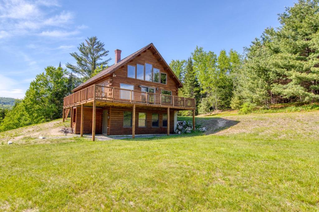 a log home on a hill with a large yard at Franconia Range View in Franconia