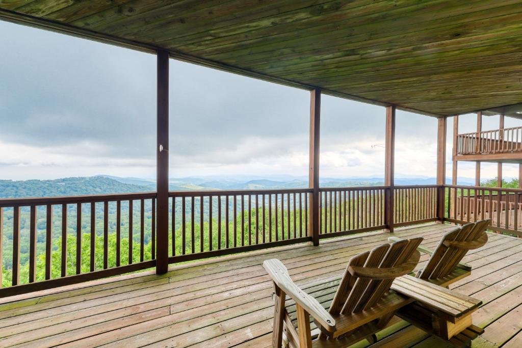 two chairs on a deck with a view of the mountains at Reserve 36-D in Sugar Mountain