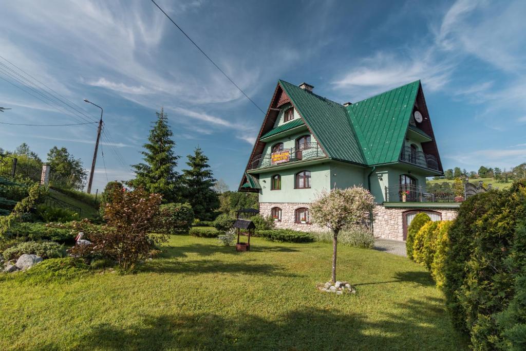 a green and white house with a green roof at U Majerczyka in Zakopane
