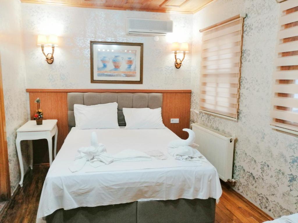 イスタンブールにあるイスタンブール　シドニー　ホテルのベッドルーム1室(ベッド1台、白いタオル2枚付)