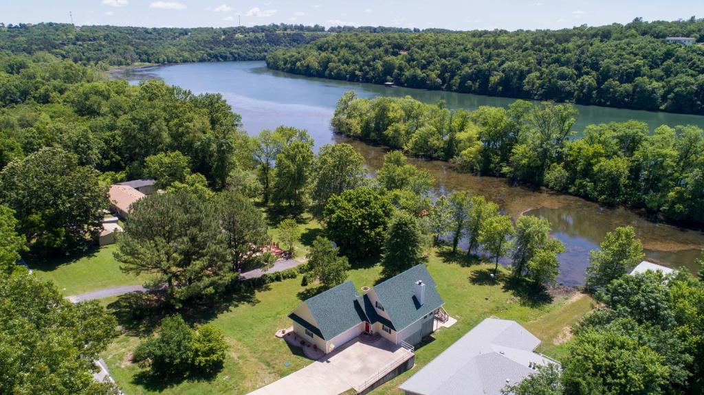 an aerial view of a house and a river at The Lake House Home in Rockaway Beach