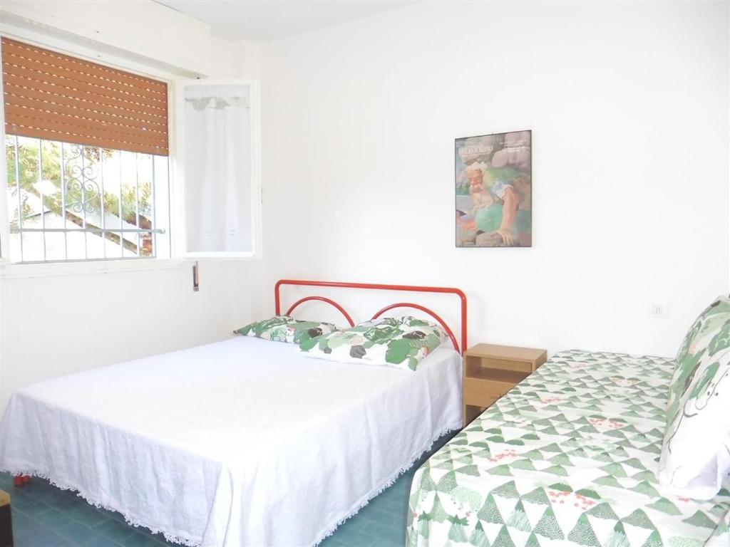 A bed or beds in a room at Appartamento Caravaggio