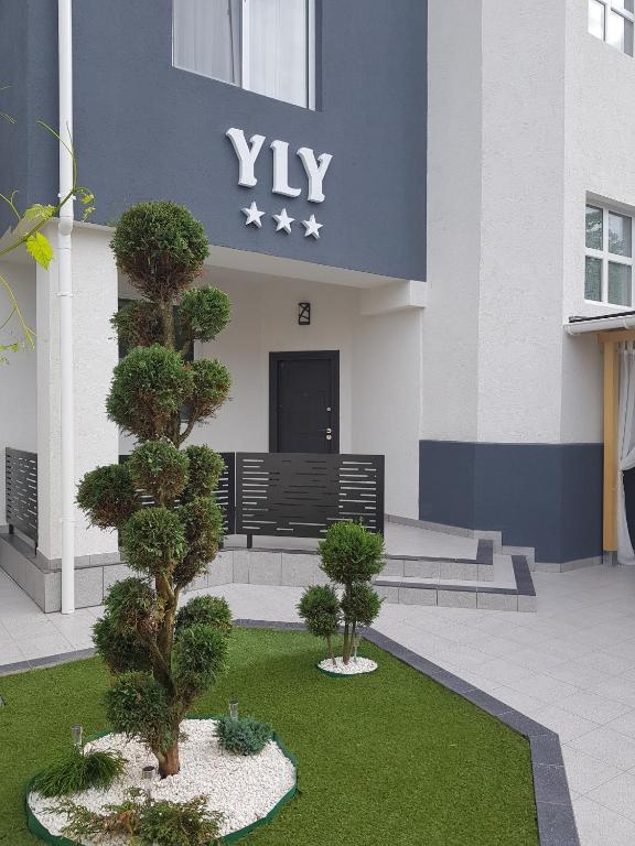 a building with two trees in front of it at Vila Yly in Eforie Nord