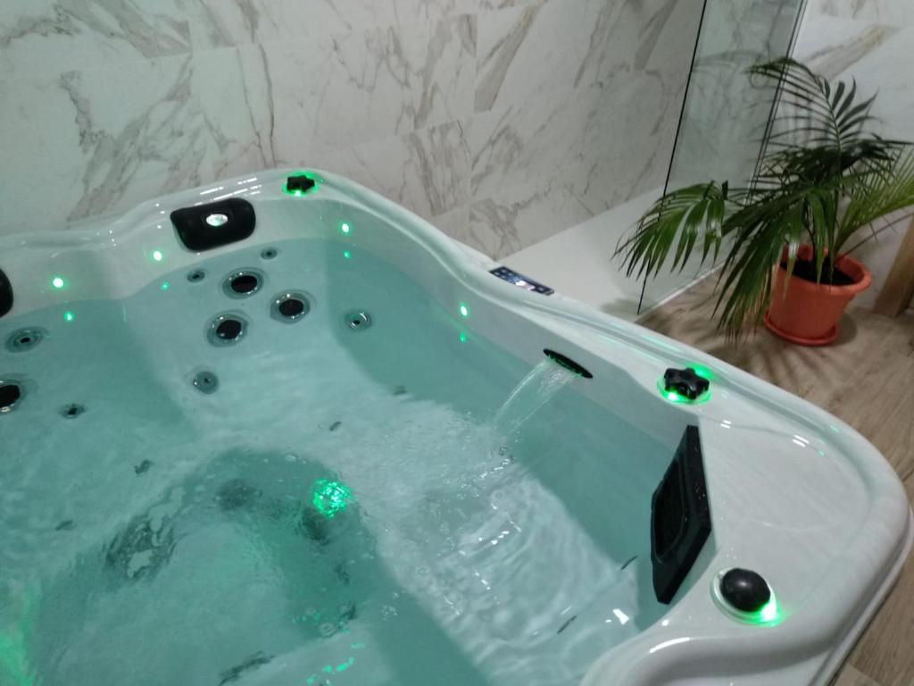 y baño con bañera con luces verdes. en Hotel Primavera, en Calasparra