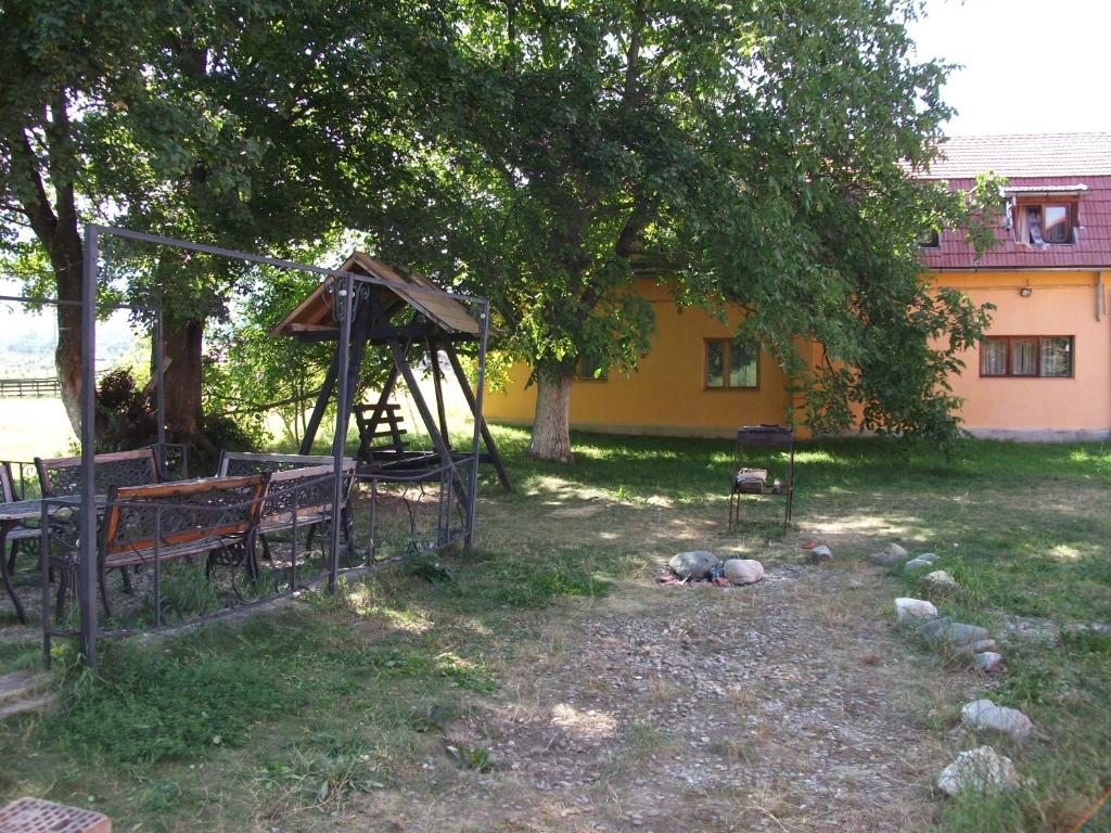 a park with a bench and a gazebo at Pensiunea Mir in Bran