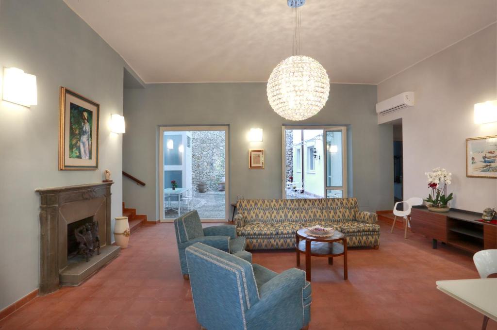 a living room with couches and a fireplace at Dimora Villa Serena Porto Selvaggio in Santa Caterina di Nardò