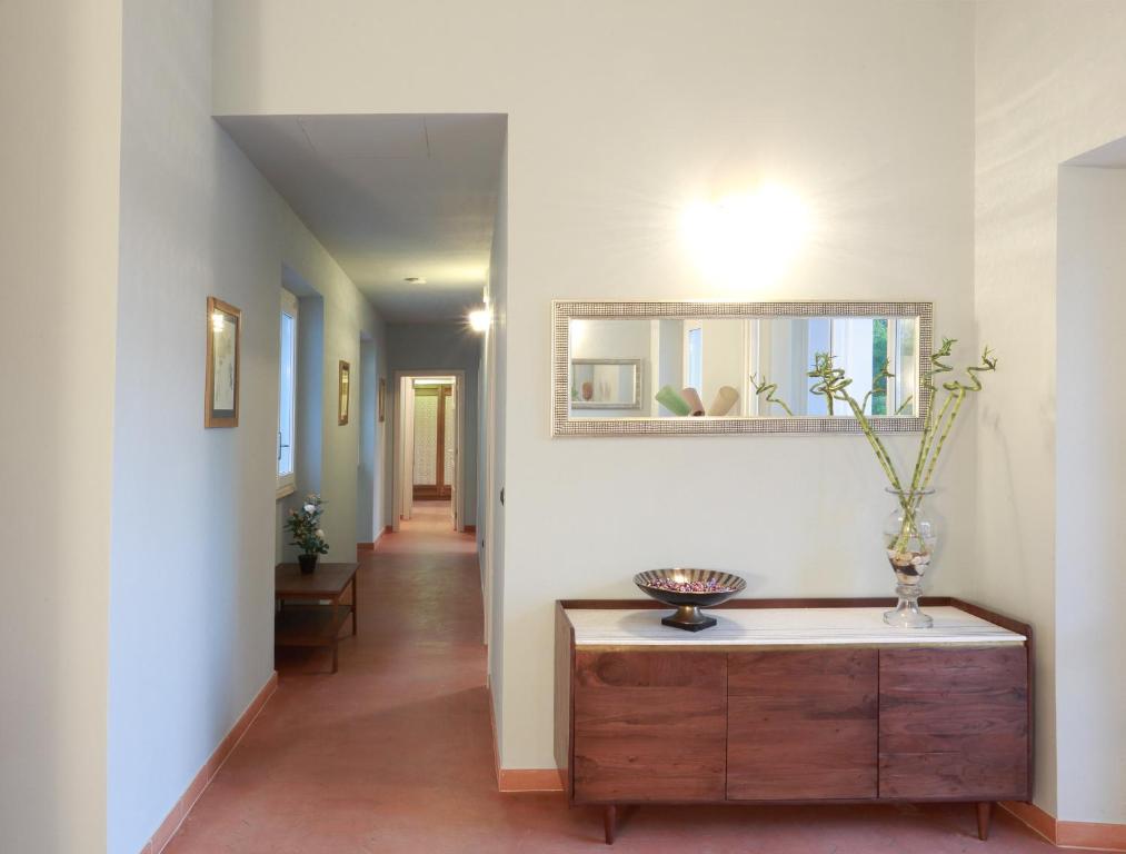 a hallway with a dresser and a mirror on a wall at Dimora Villa Serena Porto Selvaggio in Santa Caterina di Nardò
