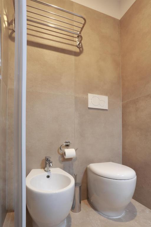 a bathroom with a white toilet and a sink at Dimora Villa Serena Porto Selvaggio in Santa Caterina di Nardò