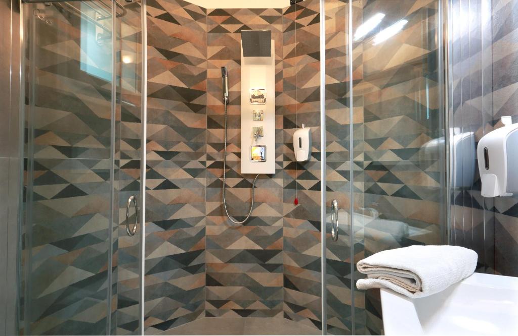 a bathroom with a shower with a glass door at Dimora Villa Serena Porto Selvaggio in Santa Caterina di Nardò